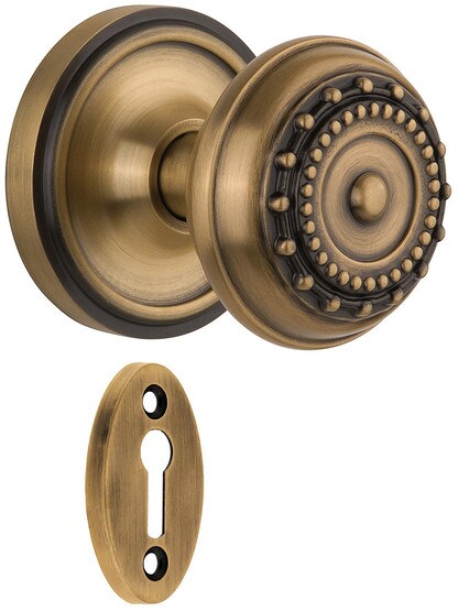 Classic Rosette Mortise Lock Set With Meadows Design Knobs in Antique Brass.